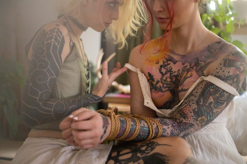 A sexy photograph of Cam Damage & Wicked Wren. Tagged with: spit, oral, bondage, cosplay, rope, intimate, submission & dominance.
