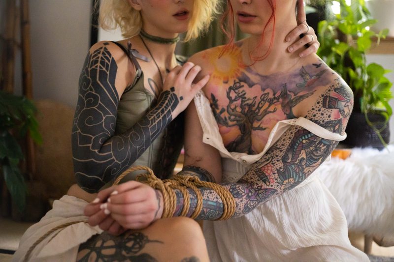 A sexy photograph of Cam Damage & Wicked Wren. Tagged with: oral, intimate, submission, dominance, bondage, cosplay & rope.