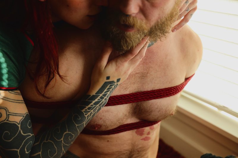 A sexy photograph of Cam Damage & Mike Panic. Tagged with: chemistry, intimate, submission, dominance, real couple, bondage & rope.